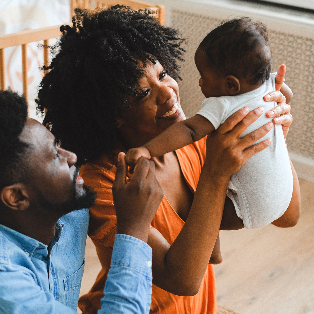 Parents carrying a baby