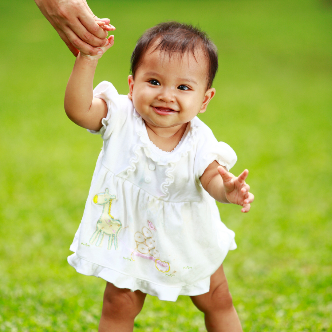 Baby holding parents hand